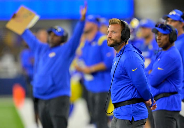 Sean McVay stands on the sideline looking out at the field